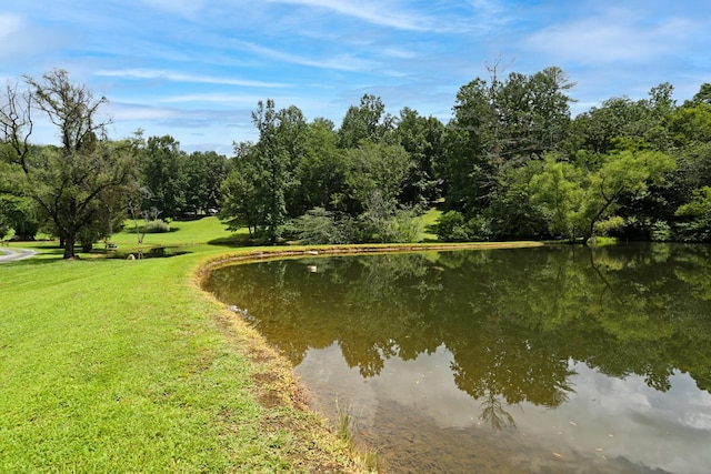 view of property's community with a lawn and a water view