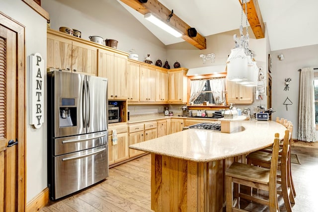 kitchen featuring a peninsula, beam ceiling, light brown cabinets, light wood-type flooring, and stainless steel appliances