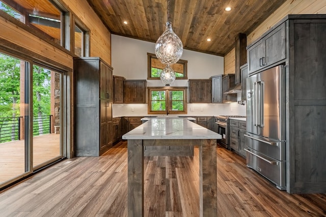 kitchen featuring decorative light fixtures, high quality appliances, dark brown cabinetry, and high vaulted ceiling