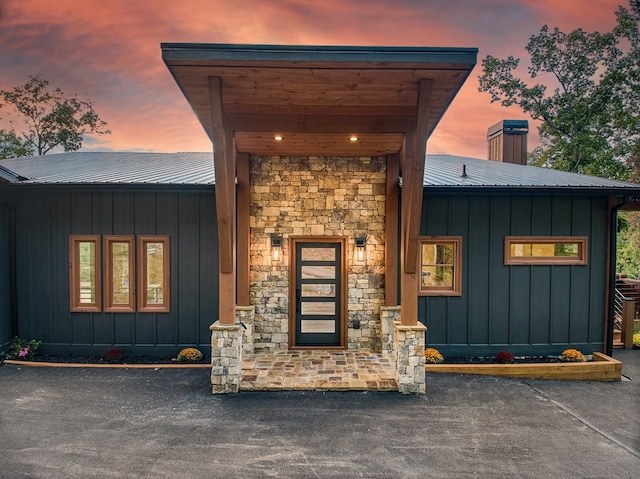 view of exterior entry at dusk