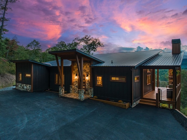 back house at dusk with a deck