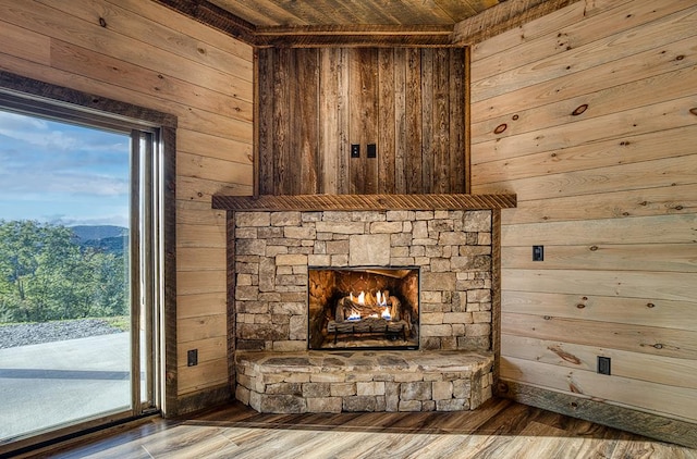 details with wood walls, a fireplace, and wood-type flooring