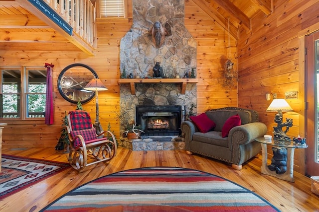 living area with high vaulted ceiling, beamed ceiling, and hardwood / wood-style floors