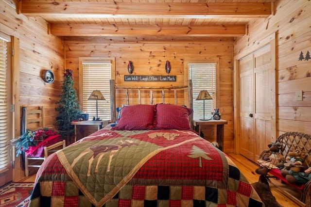 bedroom featuring wooden walls, wood ceiling, and beam ceiling