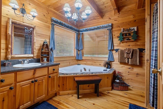 bathroom with wood ceiling, an inviting chandelier, wood-type flooring, and beamed ceiling