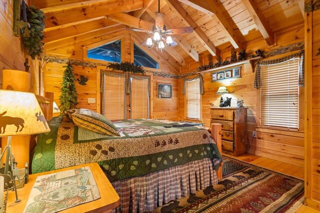 living room with hardwood / wood-style floors, wood walls, high vaulted ceiling, wood ceiling, and beam ceiling