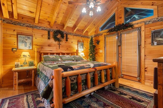 bedroom featuring hardwood / wood-style flooring, wooden walls, wood ceiling, and vaulted ceiling with beams