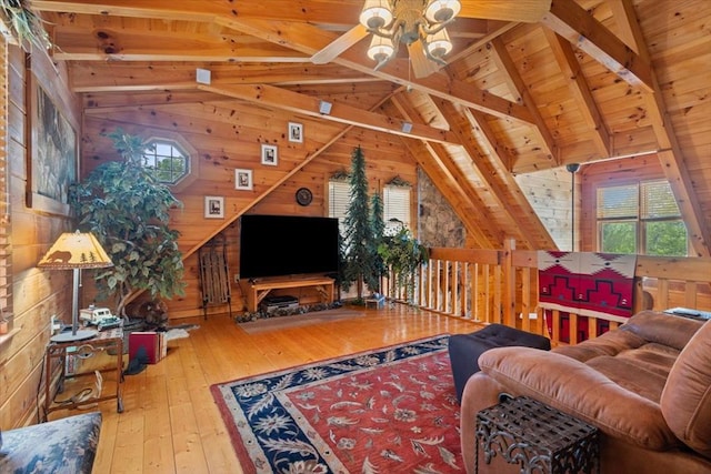 living room featuring wooden walls, hardwood / wood-style floors, ceiling fan, and wood ceiling