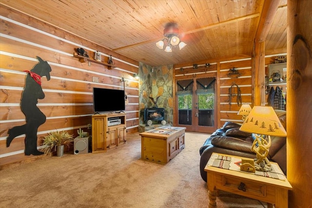 carpeted living room with french doors, wooden ceiling, and a wood stove