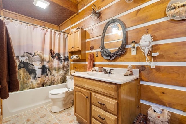 full bathroom with toilet, vanity, shower / bath combo, and wood walls