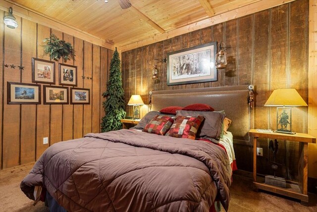 bedroom featuring ceiling fan, wood ceiling, wooden walls, and carpet