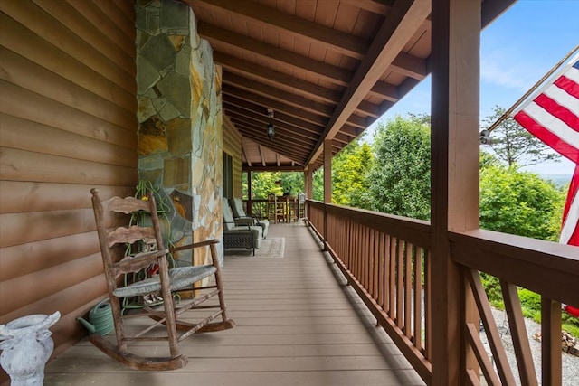 wooden terrace featuring covered porch