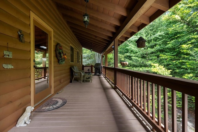 wooden terrace with a grill