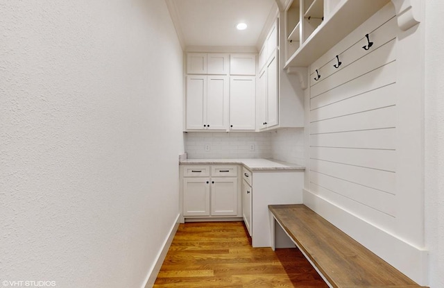 mudroom featuring light hardwood / wood-style flooring and ornamental molding