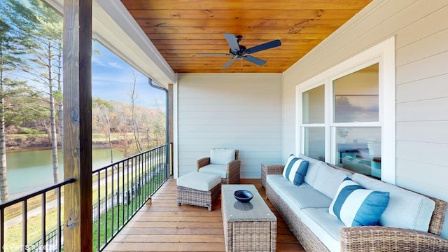 balcony featuring an outdoor living space, a water view, and ceiling fan