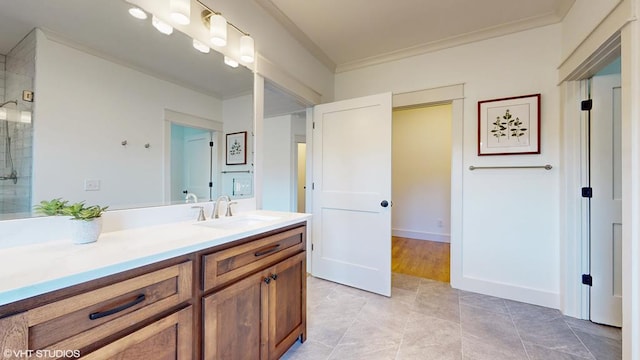 bathroom featuring tile patterned floors, vanity, a shower with shower door, and ornamental molding