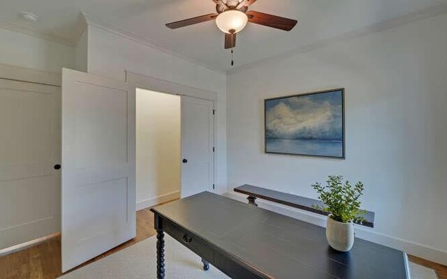 home office featuring hardwood / wood-style floors, ceiling fan, and ornamental molding