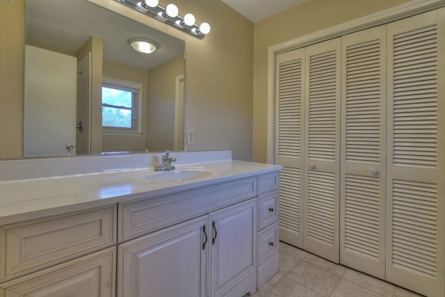 bathroom featuring tile patterned floors, a closet, and vanity