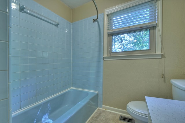 bathroom featuring visible vents, baseboards, toilet, tile patterned floors, and  shower combination