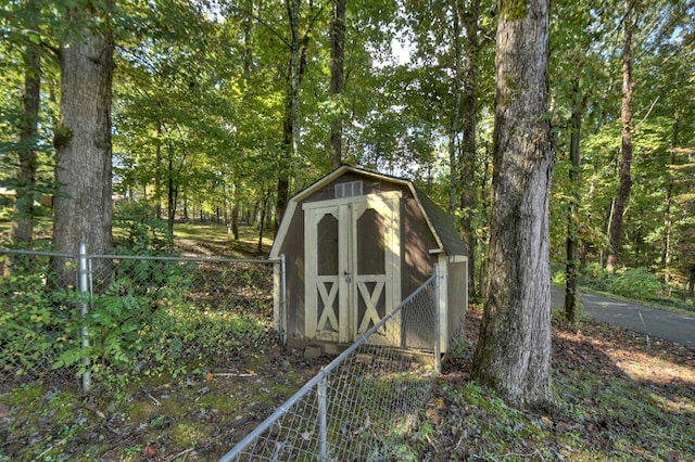 view of shed with fence