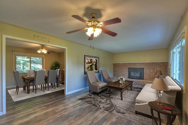 living room with dark wood-type flooring and baseboards