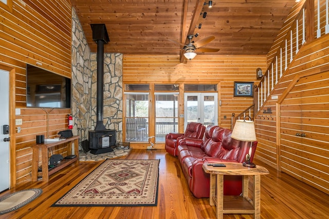 living room with high vaulted ceiling, a wood stove, hardwood / wood-style floors, and wood ceiling