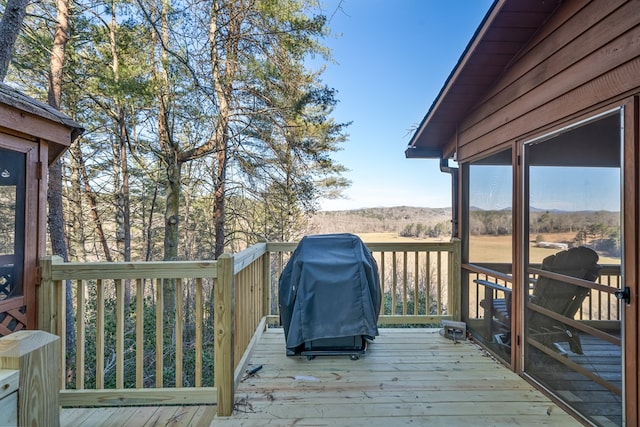 wooden deck featuring area for grilling