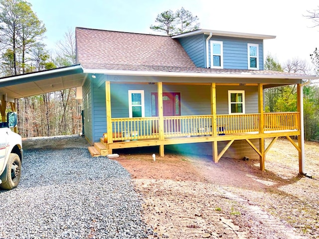 view of front of home featuring a carport and a porch