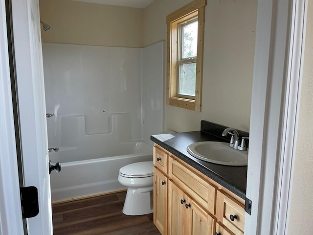 full bathroom with wood-type flooring, shower / tub combination, toilet, and vanity