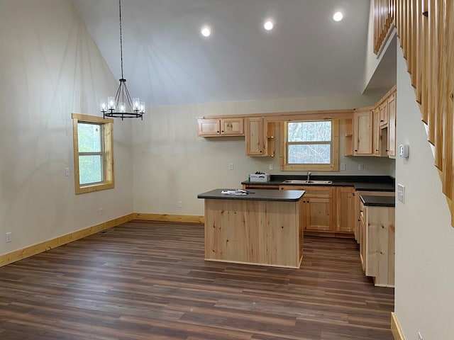 kitchen with light brown cabinets, a kitchen island, high vaulted ceiling, dark wood-type flooring, and sink