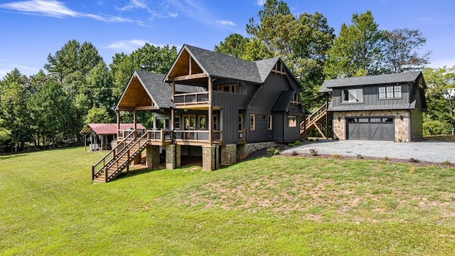 view of front facade with a garage, a front yard, and a deck