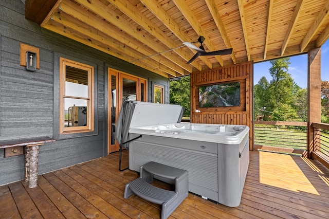 wooden deck with a hot tub and ceiling fan