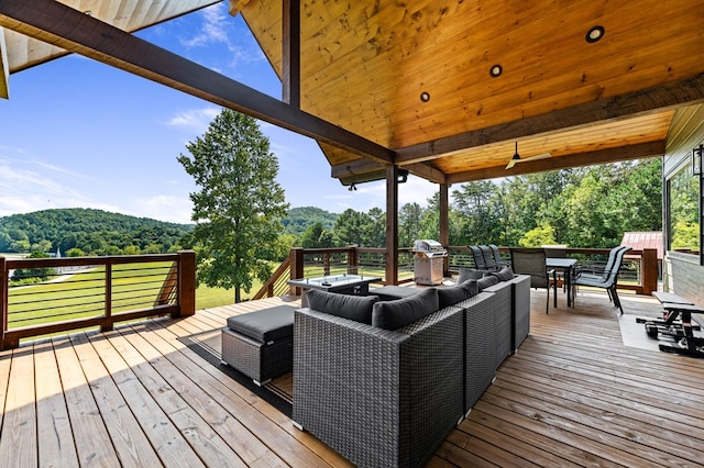 deck with outdoor lounge area and a grill