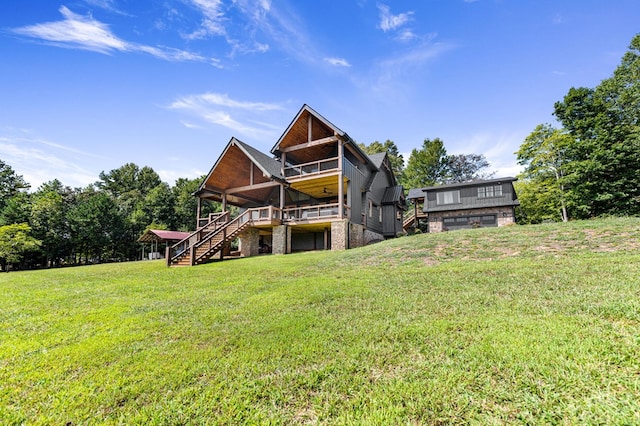 back of property with a lawn and a wooden deck