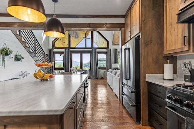 kitchen with dark hardwood / wood-style flooring, hanging light fixtures, exhaust hood, and stainless steel appliances