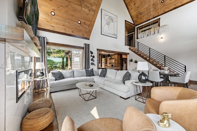 living room with high vaulted ceiling, wooden walls, and wooden ceiling