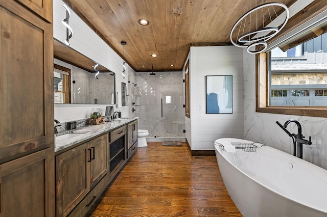 full bathroom with vanity, shower with separate bathtub, wood ceiling, hardwood / wood-style floors, and toilet