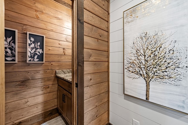 bathroom featuring wood walls