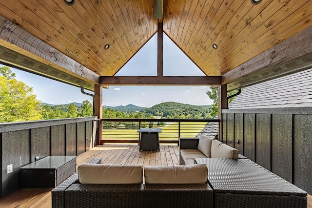 wooden terrace featuring an outdoor hangout area and a mountain view