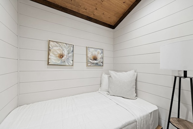 bedroom with wooden ceiling, wood walls, and lofted ceiling