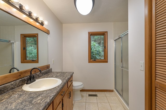 full bathroom featuring tile patterned flooring, a shower stall, visible vents, and a closet