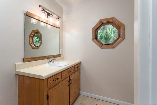 bathroom featuring tile patterned flooring, baseboards, and vanity