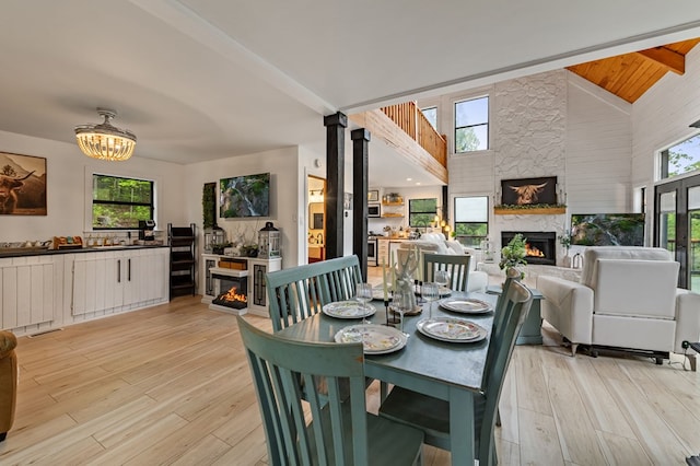 400 Creekside Dr, Mccaysville, GA 30555 - dining room with a premium fireplace, high vaulted ceiling, light wood-style floors, a chandelier, and beamed ceiling