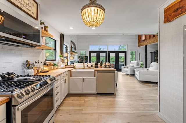 400 Creekside Dr, Mccaysville, GA 30555 - kitchen featuring stainless steel appliances, a sink, wooden counters, white cabinets, and a chandelier