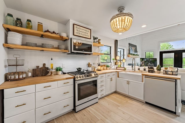 400 Creekside Dr, Mccaysville, GA 30555 - kitchen with stainless steel appliances, a sink, open shelves, white cabinetry, and wooden counters