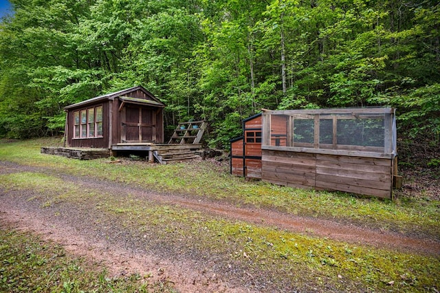 400 Creekside Dr, Mccaysville, GA 30555 - view of yard with exterior structure, an outdoor structure, and a view of trees