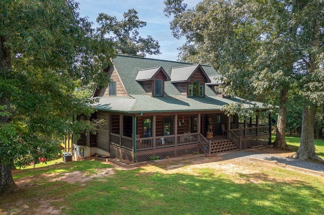 cabin featuring a porch and a front yard