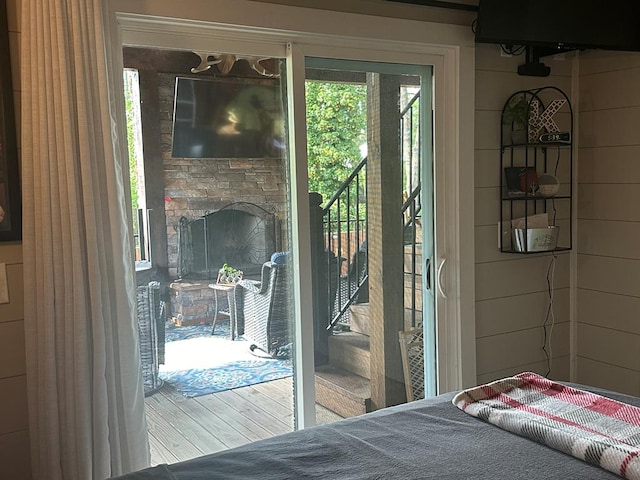 doorway to outside featuring a fireplace and a healthy amount of sunlight