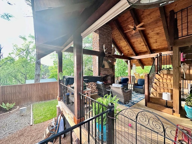 view of patio / terrace featuring an outdoor living space with a fireplace, fence private yard, and a ceiling fan