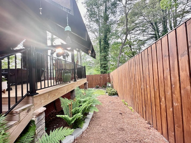 view of yard featuring a fenced backyard and a wooden deck